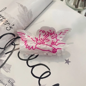 Detail of angel wing hair claw clip featuring pearlescent finish and pink outlines