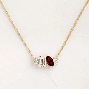 Golden necklace with emerald cut clear stone and marquise ruby pendant in 14K gold plating
