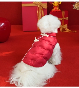 Close-up of red Chinese-style pet vest with white frog fasteners and pearl accents