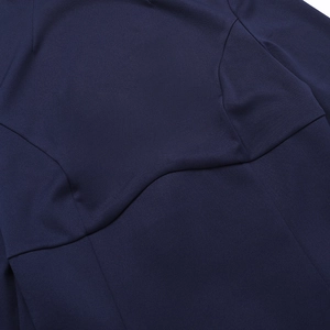 Close-up of navy blue woven fabric showing curved split stitching and premium texture