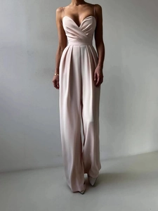 Elegant satin V-neck jumpsuit with thin straps and wide legs in soft beige pink
