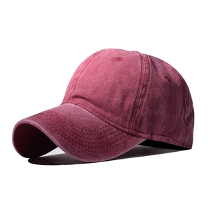 Close-up of wine red washed cotton baseball cap showing fabric texture and stitching