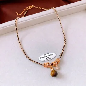 Tiger eye stone gourd pendant necklace with gold beads and black woven chain for women