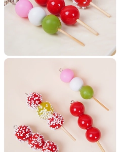 Macro shot of realistic miniature candied hawthorn and dango resin charms for DIY jewelry