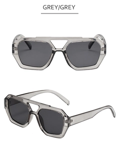 Detail view of irregular double bridge sunglasses with transparent grey geometric frames