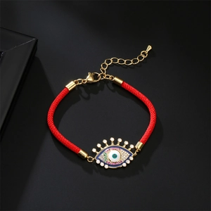 Bracelet œil porte-bonheur en corde tressée rouge avec métal doré et zircons verts