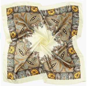 Detailed view of paisley silk satin scarf with elegant yellow and brown floral patterns