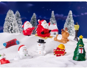 Miniature resin Christmas figurines set featuring Santa and Reindeer in a snow scene