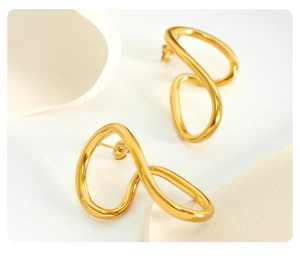 Detailed close-up of 18K gold plated irregular twist hoop earrings on a white surface