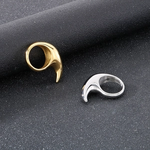 Macro shot of silver and gold crescent moon rings with a polished stainless steel finish