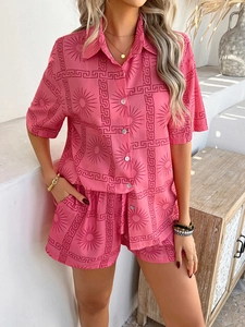Close-up of pink women's two-piece set with Greek key and sun patterns in cotton linen