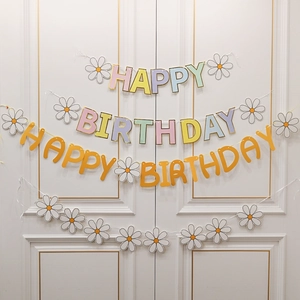Daisy themed macaron colored happy birthday party banner set with floral decorations