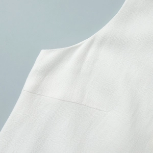 Close-up of high-quality white cotton fabric with fine texture and durable stitching detail