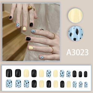 Short square press-on nails in black, yellow, and spotted blue coffee-toned Korean style