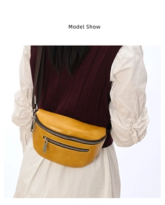 Detailed back view of yellow pebble leather chest bag with adjustable brown woven strap