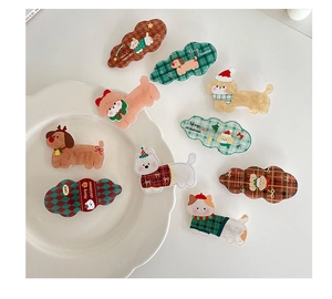 Detailed view of assorted Christmas dog hair clips in acrylic and colorful patterns