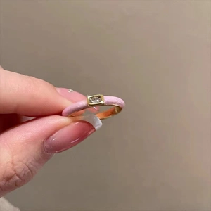 Detailed macro of pink enamel butterfly ring with gold plating and zircon stone