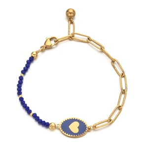 Detailed shot of golden paperclip chain bracelet with blue heart charm and faceted beads