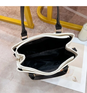 Detailed top view showing the dual-layer interior structure and zipper pocket of the handbag