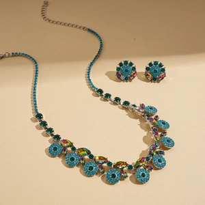 Vintage crystal jewelry set featuring peacock blue rhinestone necklace and stud earrings