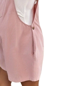 Detail of pink cotton maternity overalls with side pocket and button stitching craftsmanship