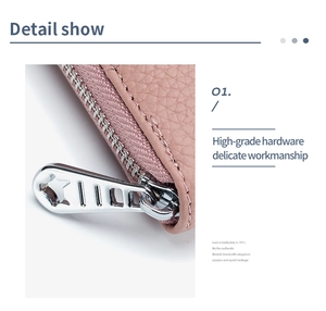 Macro detail of high-grade silver star-shaped metal zipper on pink lychee leather wallet