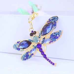 Golden dragonfly keychain featuring blue and purple rhinestones and crystal wings