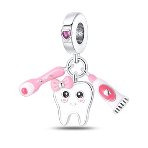Detailed silver tooth pendant with pink bow, toothbrush, and heart-shaped gemstone charm