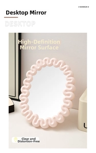 Detail shot of a wavy pink desk mirror featuring a matte finish and oval glass surface