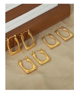Detailed close-up of three pairs of vintage gold plated geometric earrings with sunray texture