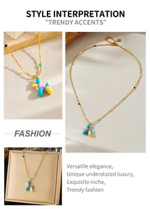 Detail view of colorful balloon dog pendant necklace with gold beaded chain and lobster clasp