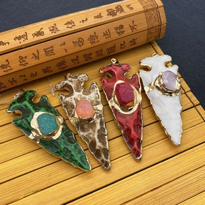 Arrowhead natural stone pendants with gold plated edges and center oval gemstones
