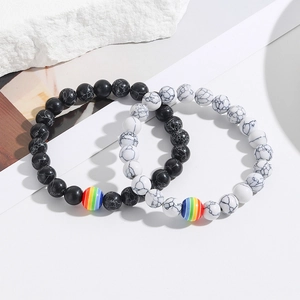 Detail of black and white marble beaded bracelets with rainbow striped accent beads