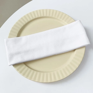 Detail of white ribbed knit headband texture on a decorative cream ceramic tray