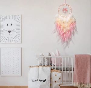 Pink dream catcher wall decor with tree of life and LED lights in a cozy baby room