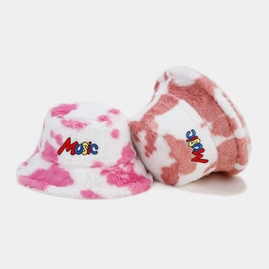Plush faux fur cow print bucket hats with MUSIC embroidery in pink and brown tones