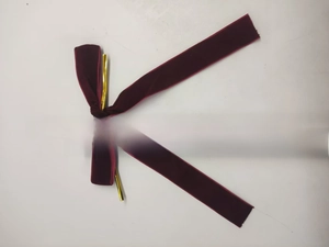 Detail view of a 20cm dark red velvet Christmas bow with gold wire for holiday decoration