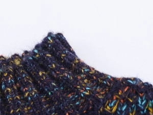 Macro detail of thick multi-color mélange knit sweater with ribbed cuffs in navy and orange