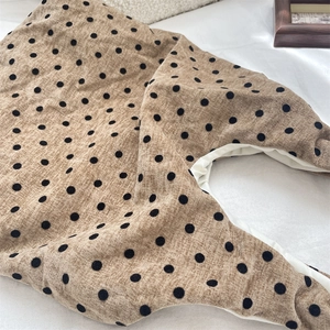 Detailed macro view of khaki polka dot canvas bag fabric showing texture and inner lining