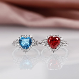 Elegant heart-shaped blue and red topaz rings set in silver metal with small gems