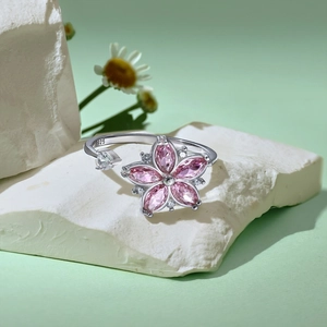 Macro detail of S925 sterling silver spinning flower ring with pink crystals