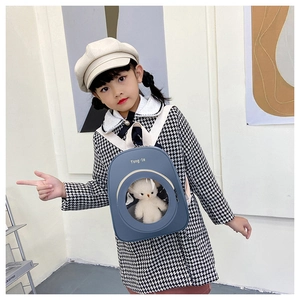 Toddler backpack featuring a clear window with a cute plush bear and cream straps