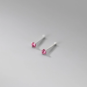 Macro shot of rose pink gemstone earrings with sterling silver four-claw settings