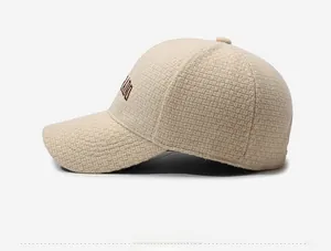Side view of beige knitted baseball cap featuring MIU embroidery and textured fabric