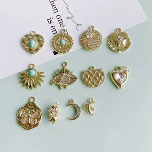 Golden DIY charms set featuring heart, evil eye, and moon shapes with turquoise accents