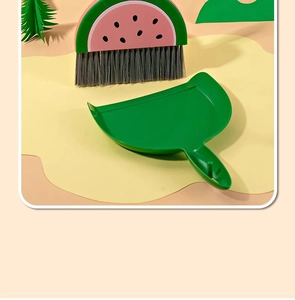 Detail of the watermelon design mini broom set with a green dustpan for desk cleaning