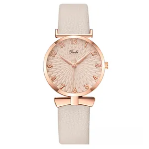 Detail view of champagne sunburst dial with rose gold case and light pink leather strap