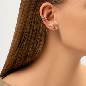 Macro detail of silver snake stud and minimalist double-layer ear cuff on model