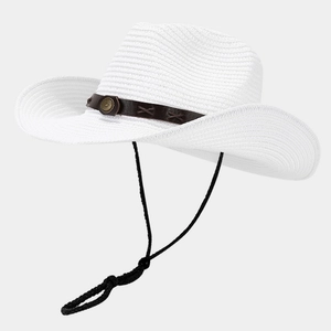 Close-up of woven straw hat featuring brown leather band and brass metal ornament