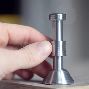 Moondrop kinetic desk toy in silver metal showing gravity-defying moon and mars fall